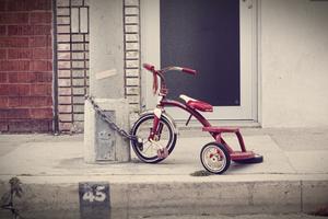 3-wheel bicycle chained to a pole